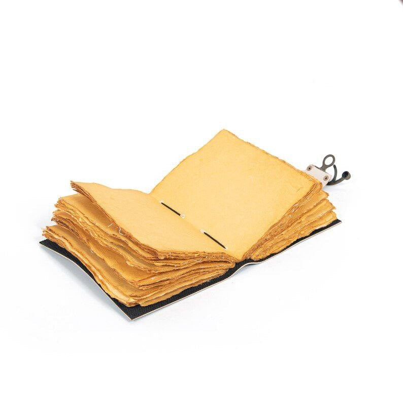 Retkatha handcrafted leather journal with 200 unlined vintage deckle edge pages and antique brass clasp lock.