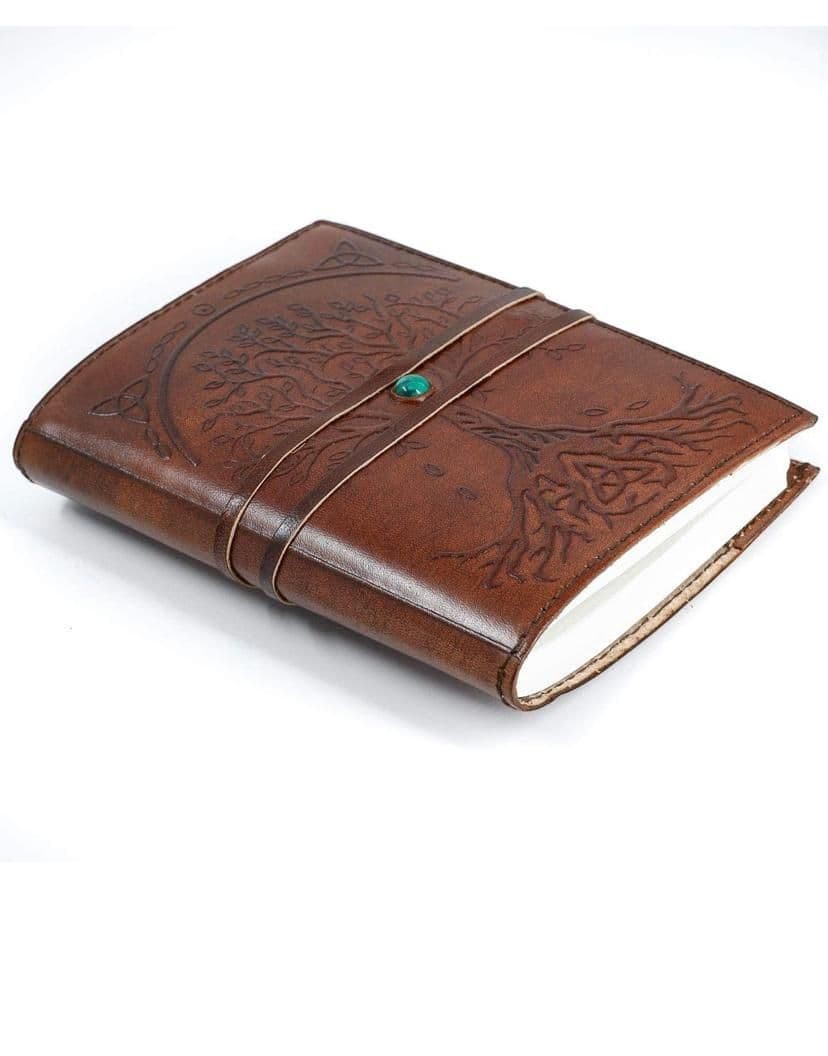 Retkatha cognac buffalo leather journal with embossed Tree of Life, Celtic knotwork, and a turquoise strap closure.