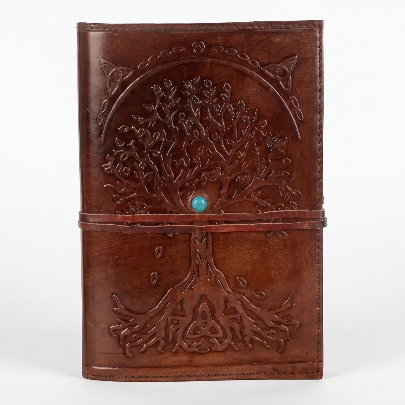 Retkatha cognac brown buffalo leather journal with embossed Tree of Life, Celtic knotwork, and turquoise stone clasp.